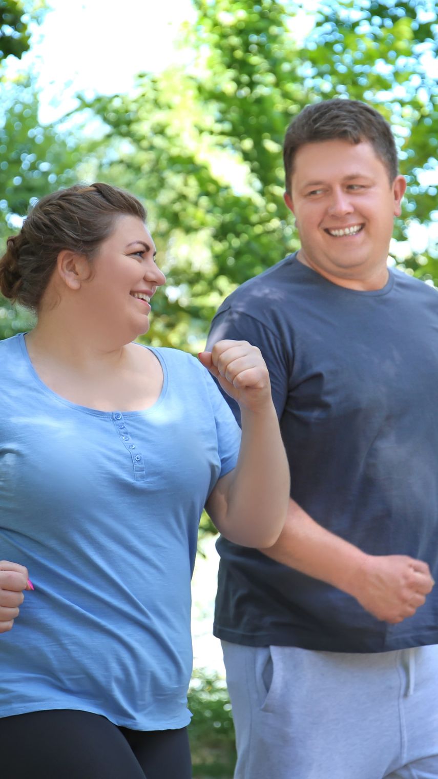 a happy couple walking outside for their weight loss treatment
